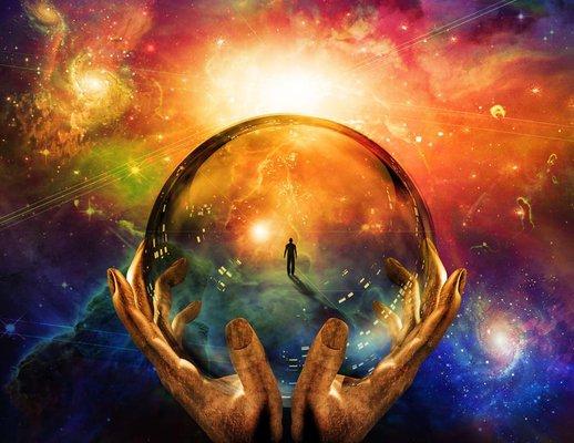 Two hands holding a glowing crystal ball that reveals a silhouette of a person standing within a vibrant, colorful nebula and starry galaxy.